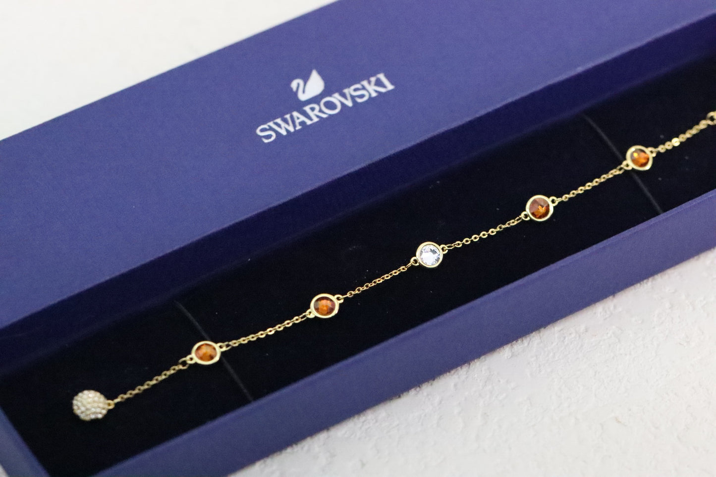 Gold-trimmed orange magnetic bracelet